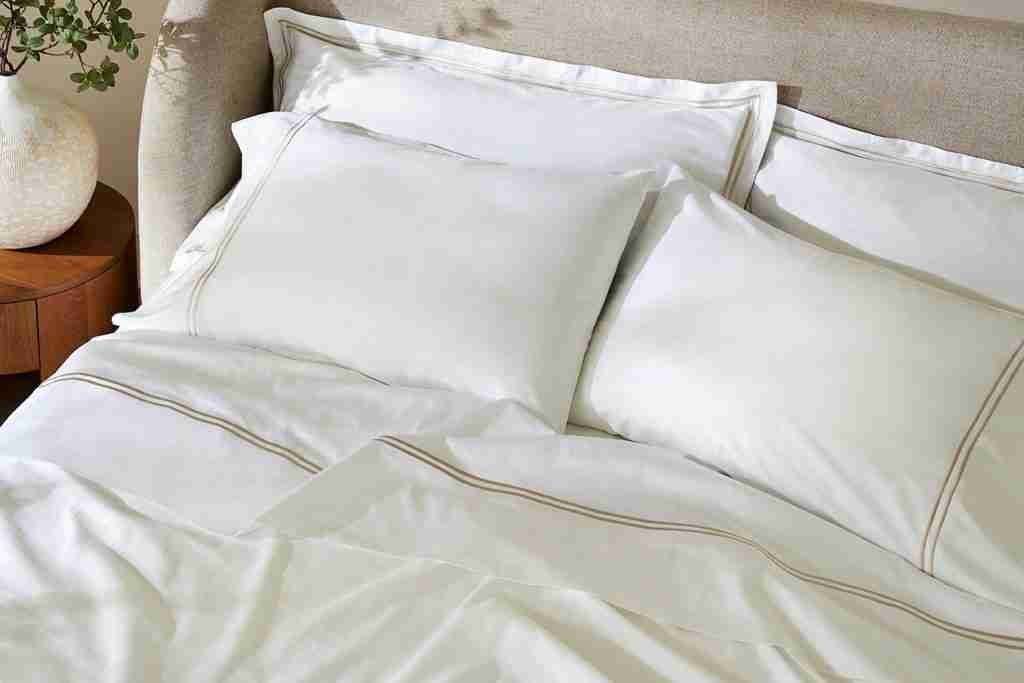 embroidered hotel style sheets lifestyle close up taupe 3 2